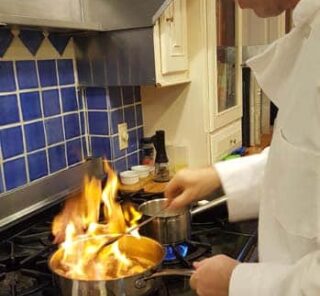 Chef cooking with flaming pan