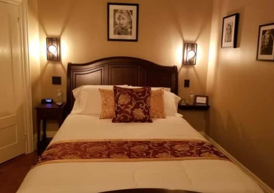 Betty Davis Room with bed with burgundy and gold accents