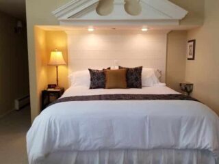 bedroom with brown accents and dramatic headboard