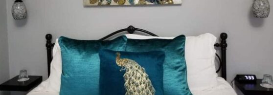 picture over bed decorated in aqua pillows