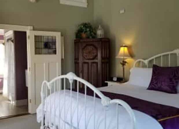 bedroom with green walls and decorated with purple accents