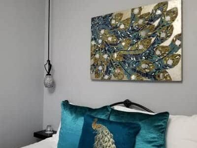 picture over bed decorated in aqua pillows