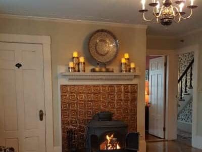 room with iron fireplace with blazing fire